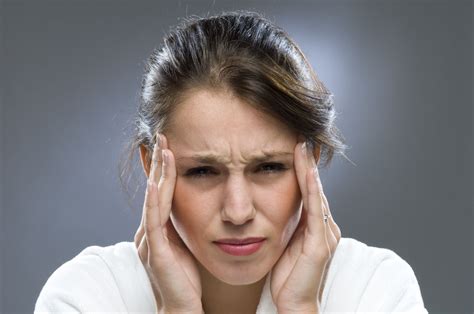 Woman with headache which is a sign of low magnesium